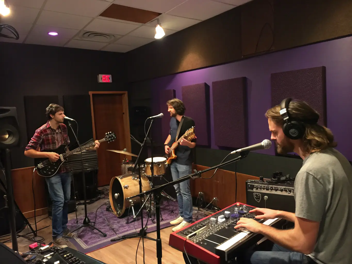 A diverse group of musicians collaborating in a recording studio, showcasing the collaborative opportunities facilitated by BHM BLOCK 'HOUSE.
